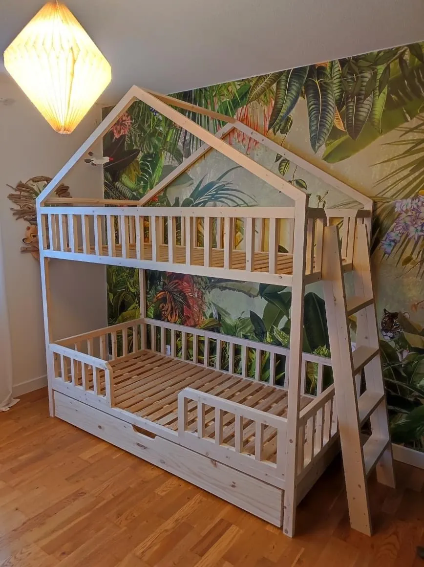 Lit superposé artisanal en bois avec structure cabane et échelle intégrée, idéal pour optimiser l’espace d’une chambre d’enfant.